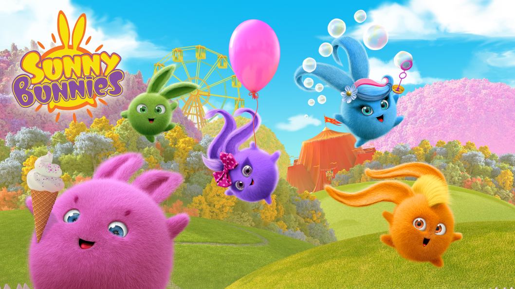 Des personnages ronds et duveteux de différentes couleurs sautent à travers un champ vert avec un ciel bleu en arrière-plan.